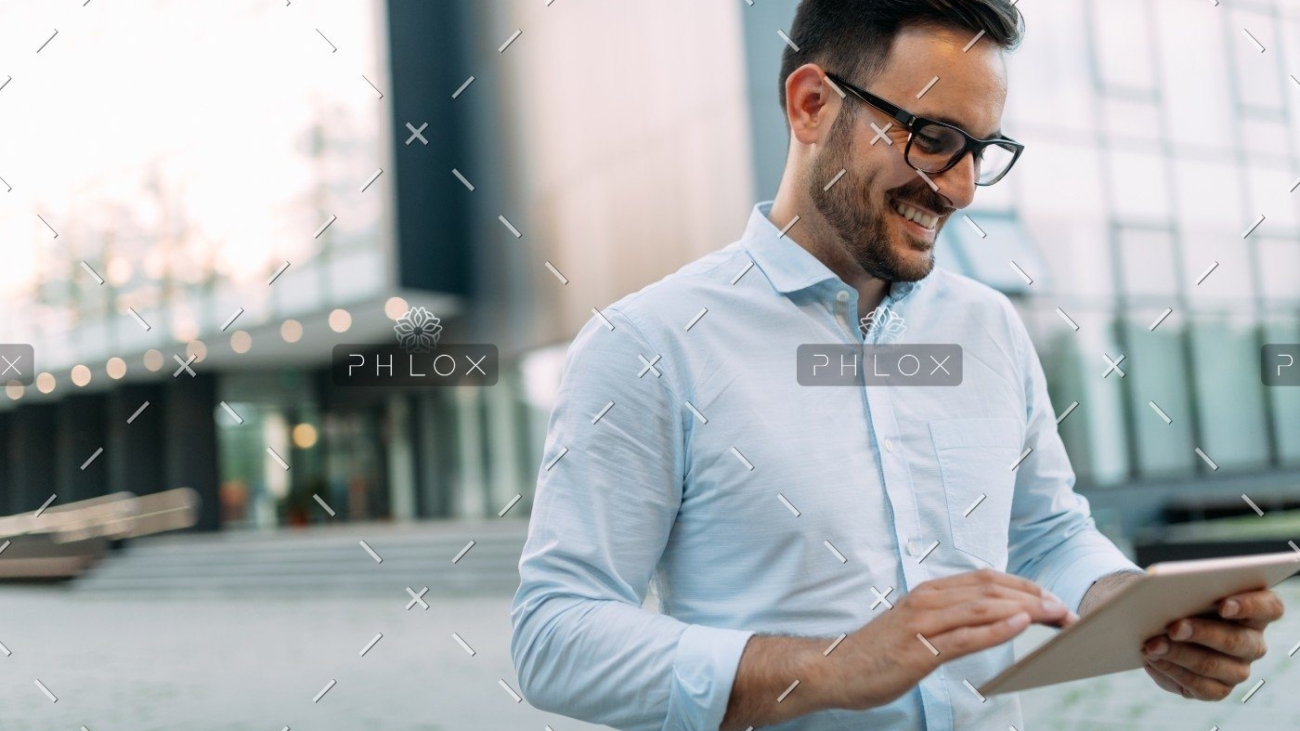 demo-attachment-336-portrait-of-businessman-in-glasses-holding-tablet-AWVHCJU