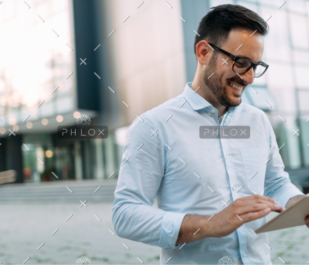 demo-attachment-336-portrait-of-businessman-in-glasses-holding-tablet-AWVHCJU